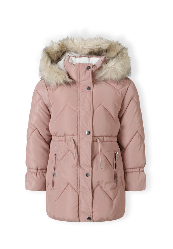 Front of a dusty pink long padded coat with cream fluffy hood trim, zigzag quilting and two zipped pockets.