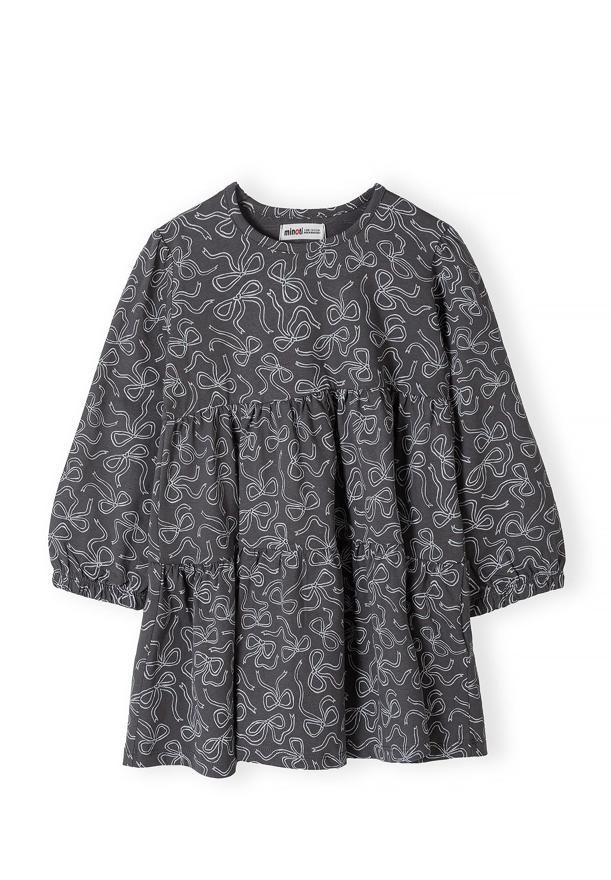 Front of charcoal girls' dress with white outline bows and gathered skirt tiers.