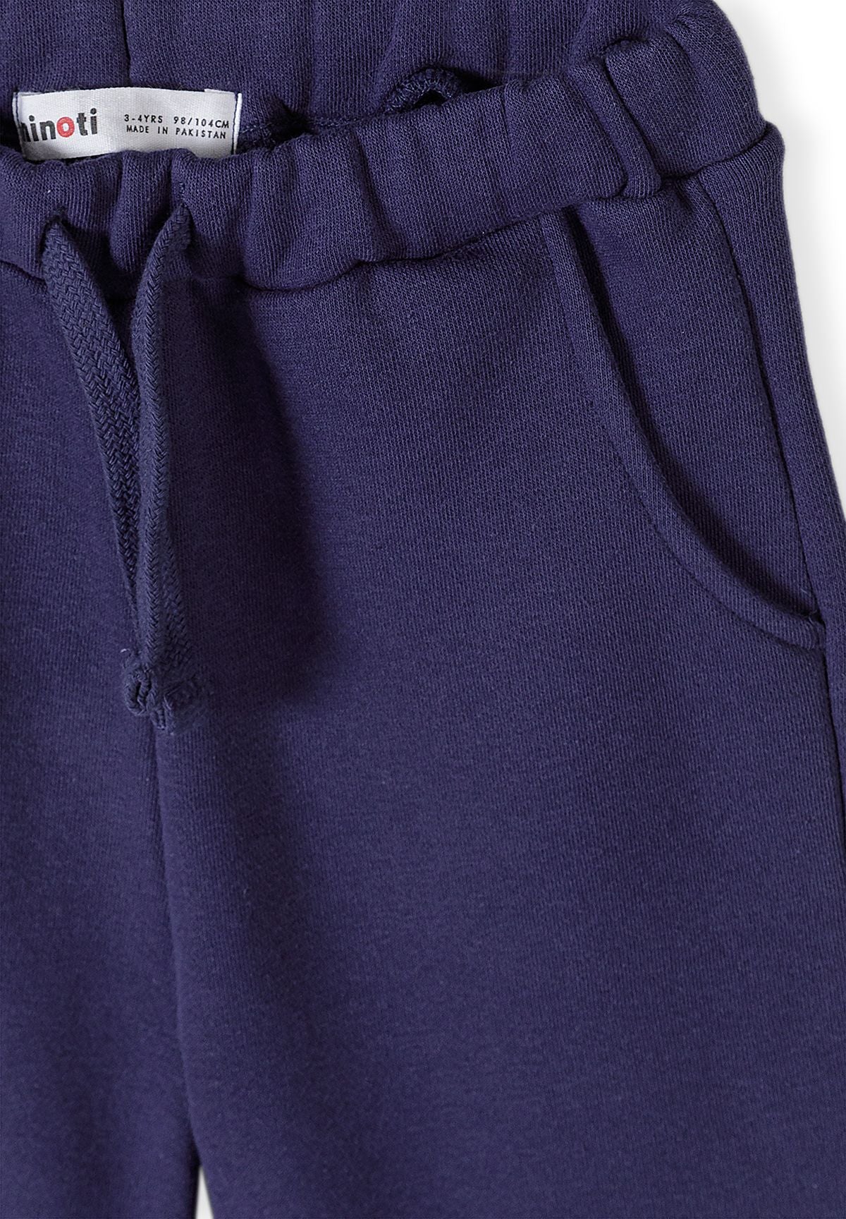Survêtement pour fille composé d'un sweat-shirt bleu foncé à volants et d'un pantalon de jogging, gros plan sur la taille à cordon.