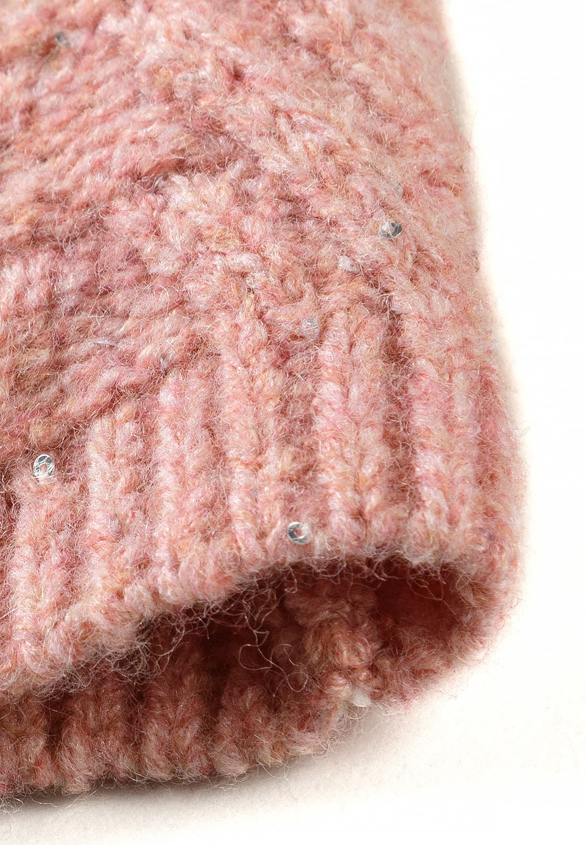 Close-up of dusty pink fuzzy snood knit with small reflective sequins.