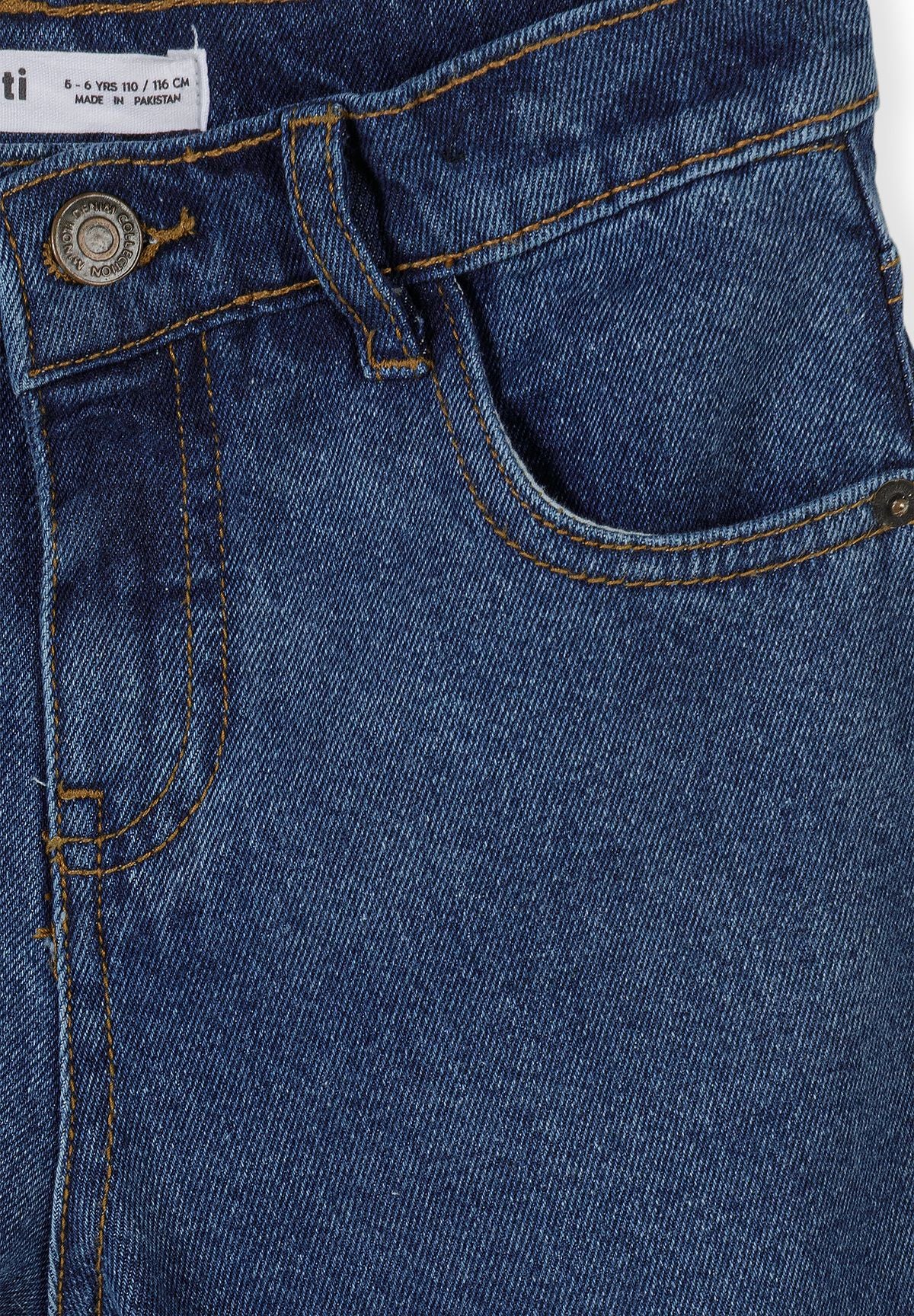 Close-up of blue jeans waistband with metal button, belt loop and coin pocket.