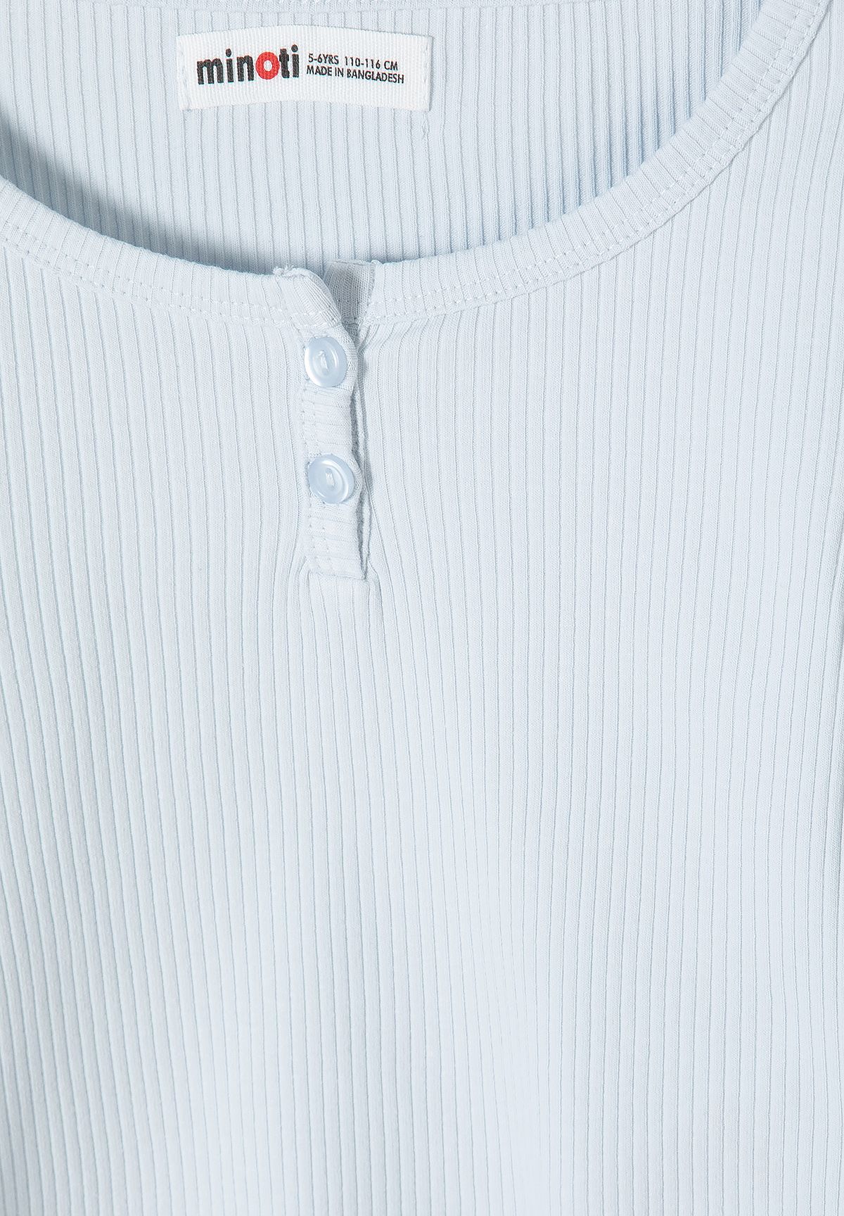 Close-up of pale blue ribbed top's two-button neckline.