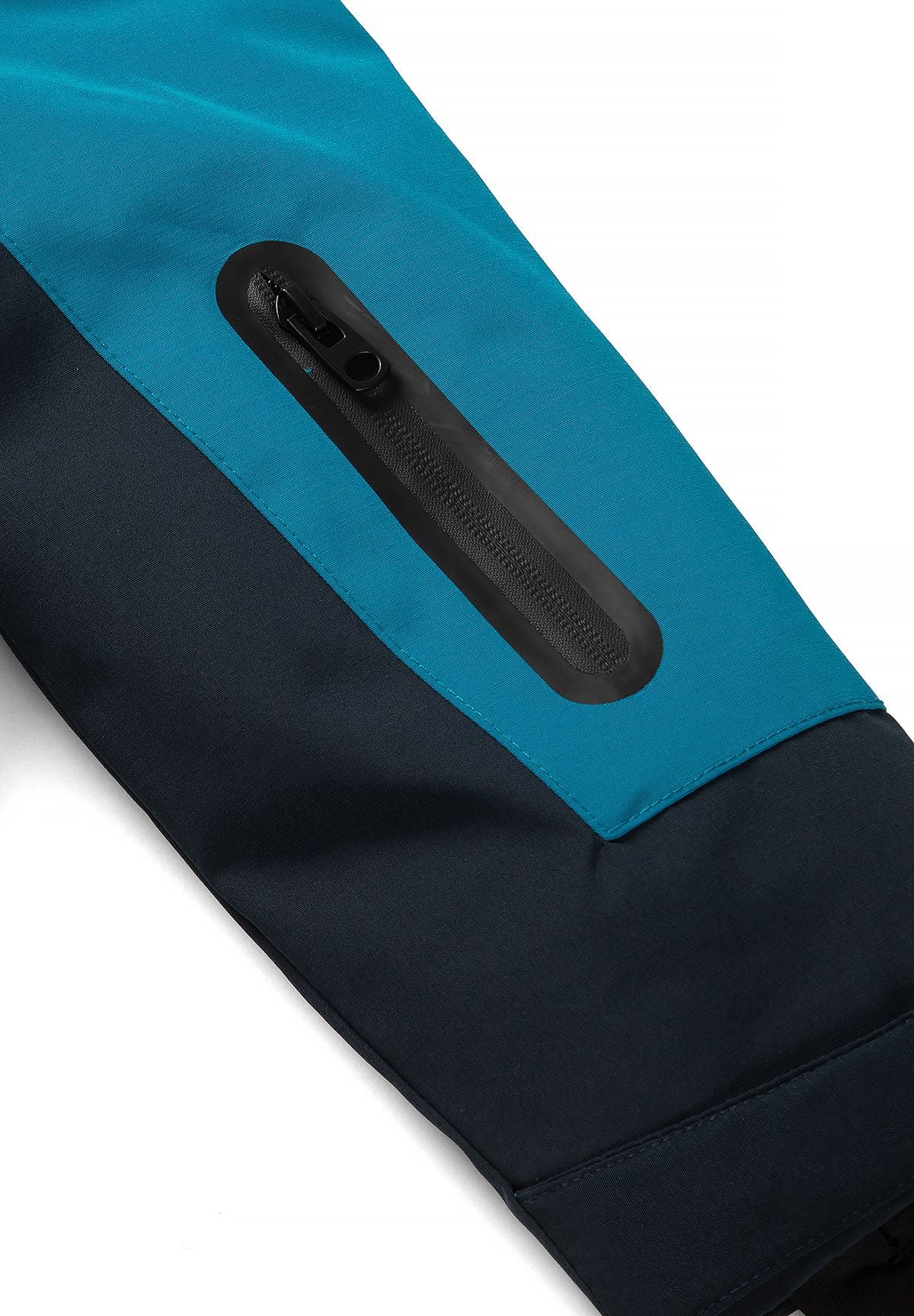Long black vertical zip pocket on the teal upper sleeve above the navy cuff panel.