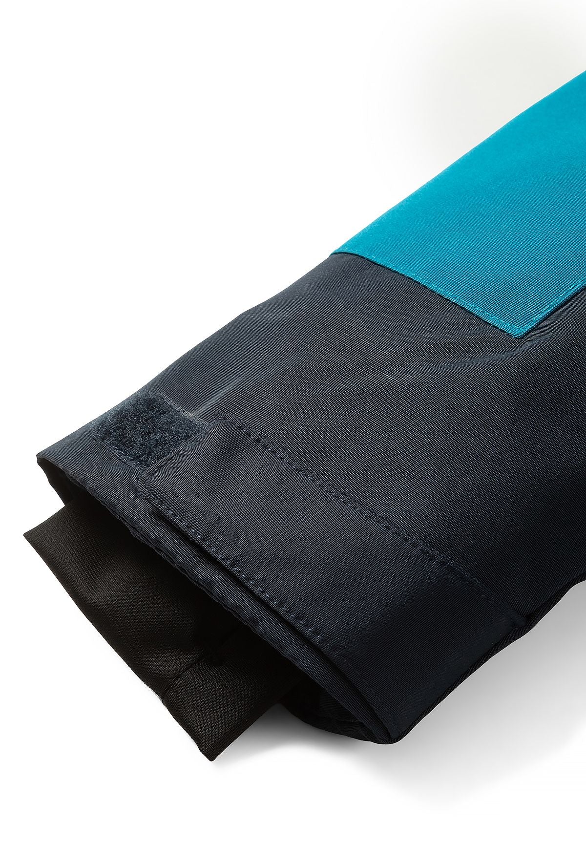 Teal and navy parka cuff with a hook-and-loop adjustment tab and dark inner cuff.