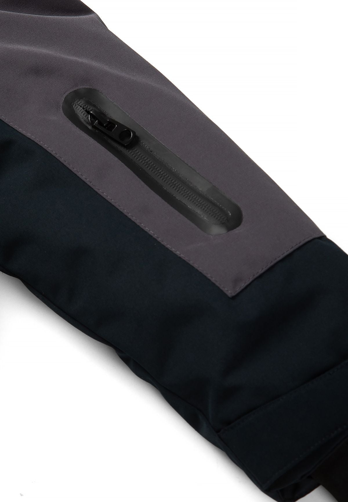Close-up of a vertical black zip pocket set into the parka's charcoal upper sleeve.