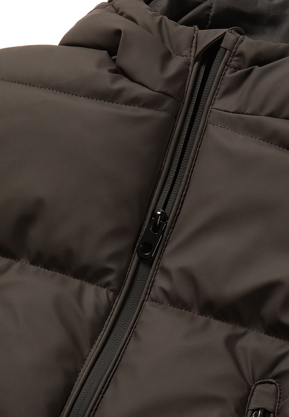 Close-up of the black front zip running between wide padded bands on a dark brown jacket.