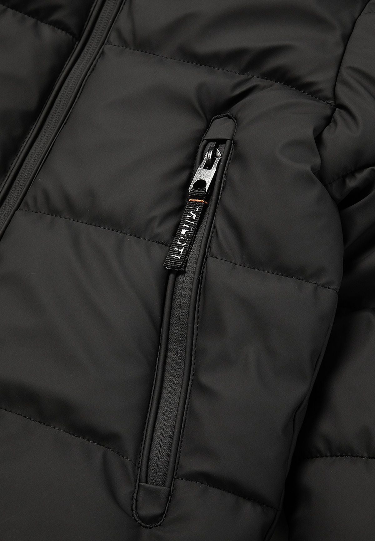 Close-up of a long vertical black zip pocket with silver pull and branded black tab on the puffer jacket.