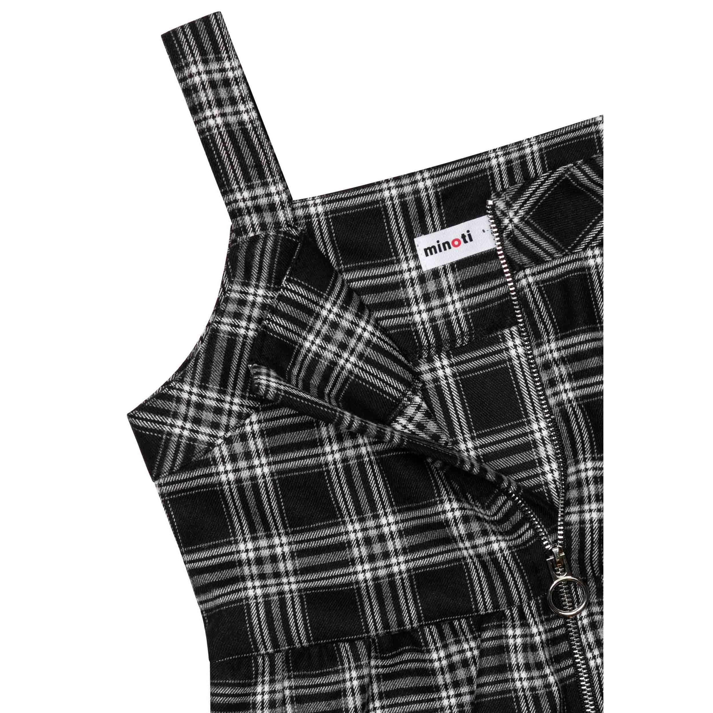 Close-up detail of black checked pattern fabric with silver half-zip and Minoti label visible