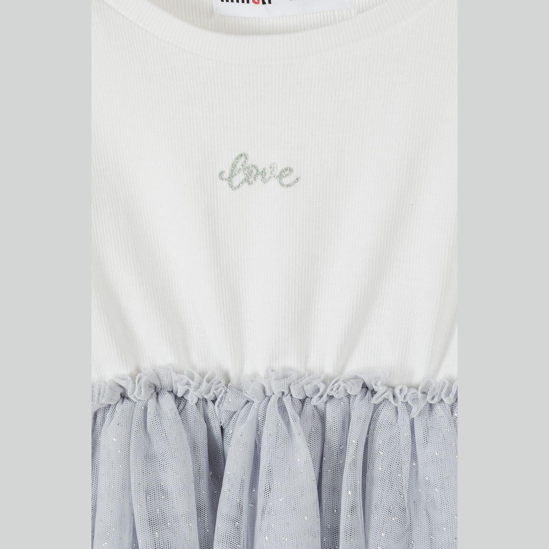 Close-up detail of dress showing Minoti label, glittery Love text on cream waffle fabric and grey mesh skirt attachment