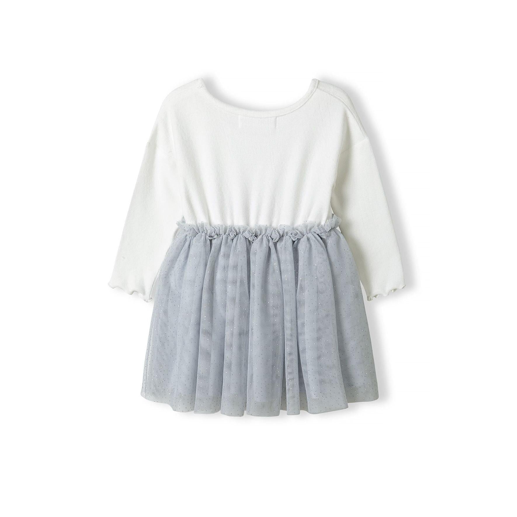 Flat lay of cream and grey mesh dress showing waffle jersey top and flowing tulle skirt on white background