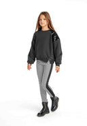 Girls crew sweatshirt with sequin and eyelet detail black 3-14y. Soft black fabric, balloon sleeves, and decorative sequins. Stylish and comfortable.
