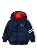 Boys padded bomber jacket with snorkel hood navy 2-14y, featuring a warm navy exterior, vibrant red lining, and sporty white stripes.