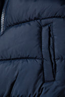 Navy boys padded bomber jacket with snorkel hood, featuring quilted texture and practical side pocket, size 2-14y.