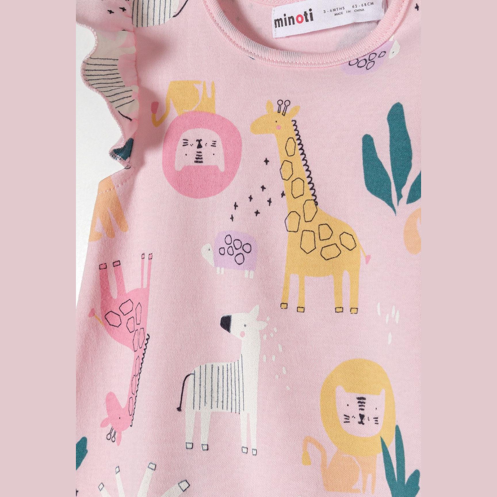 Close-up detail of pink romper showing safari animal print including yellow giraffe, pink lion face, teal leaves and geometric patterns on soft cotton fabric