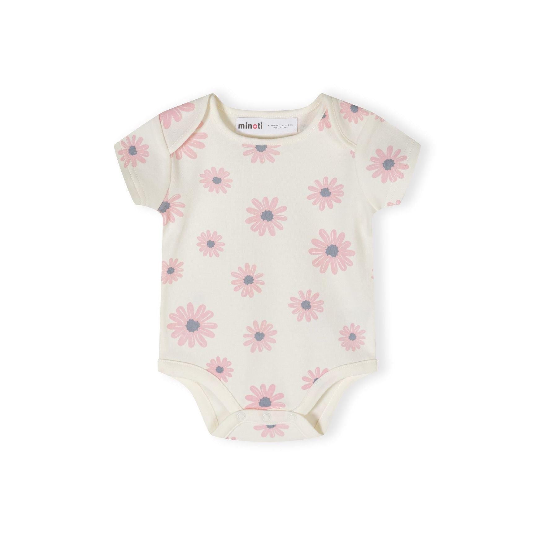 Single light pink short sleeve bodysuit with white daisy flower print pattern scattered across the fabric on white background