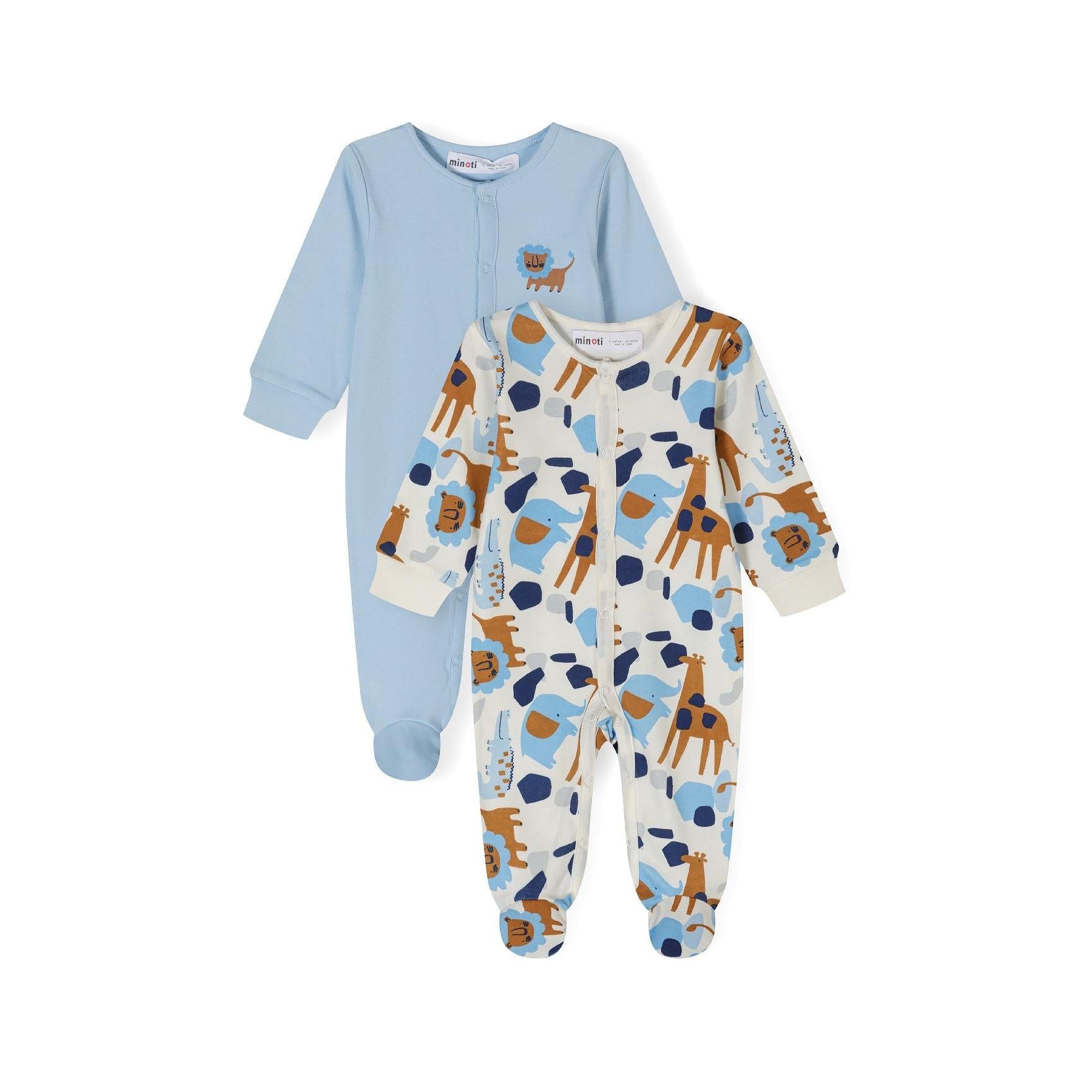 Two baby sleepsuits displayed side by side - light blue sleepsuit with small brown puppy embroidery and white sleepsuit with colorful safari animal print including elephants and giraffes