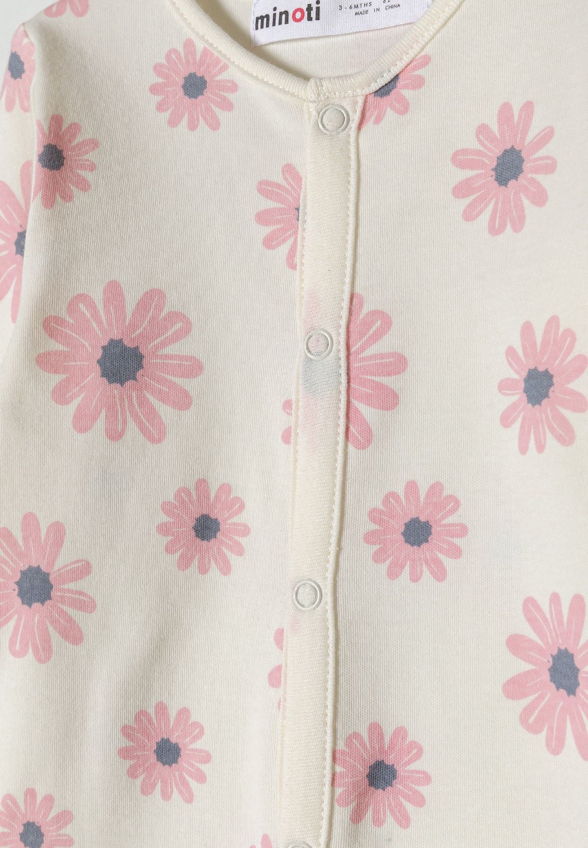 Pink and cream sleepsuits, floral popper detail.