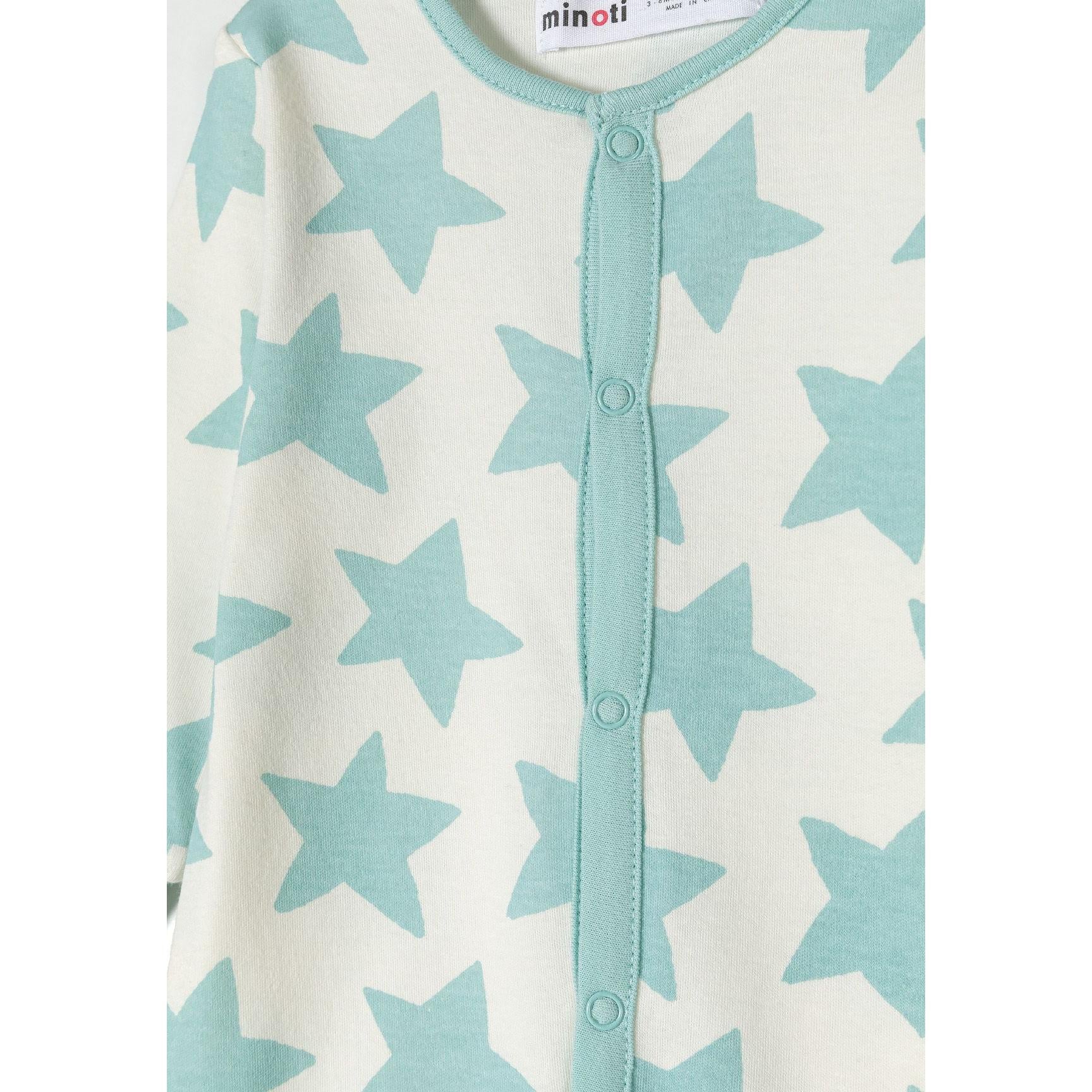 Close-up detail of mint sleepsuit with black dinosaur print pattern and snap button closure