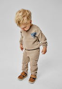 Boys beige long sleeve sweatshirt and jogger set, featuring ribbed cuffs and side pockets.