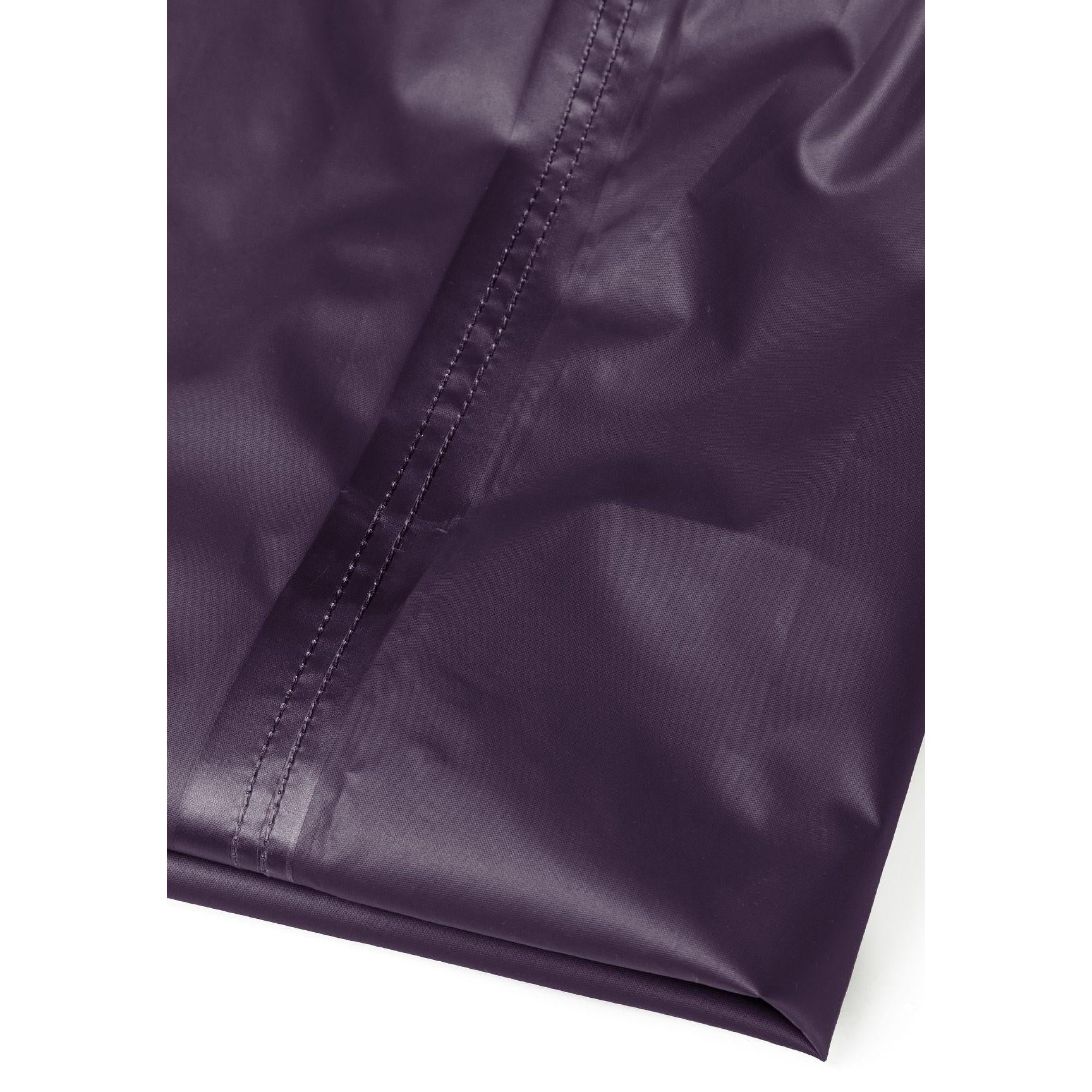 Close-up detail of purple waterproof overpants showing elasticated waistband with gathered fabric and seam construction