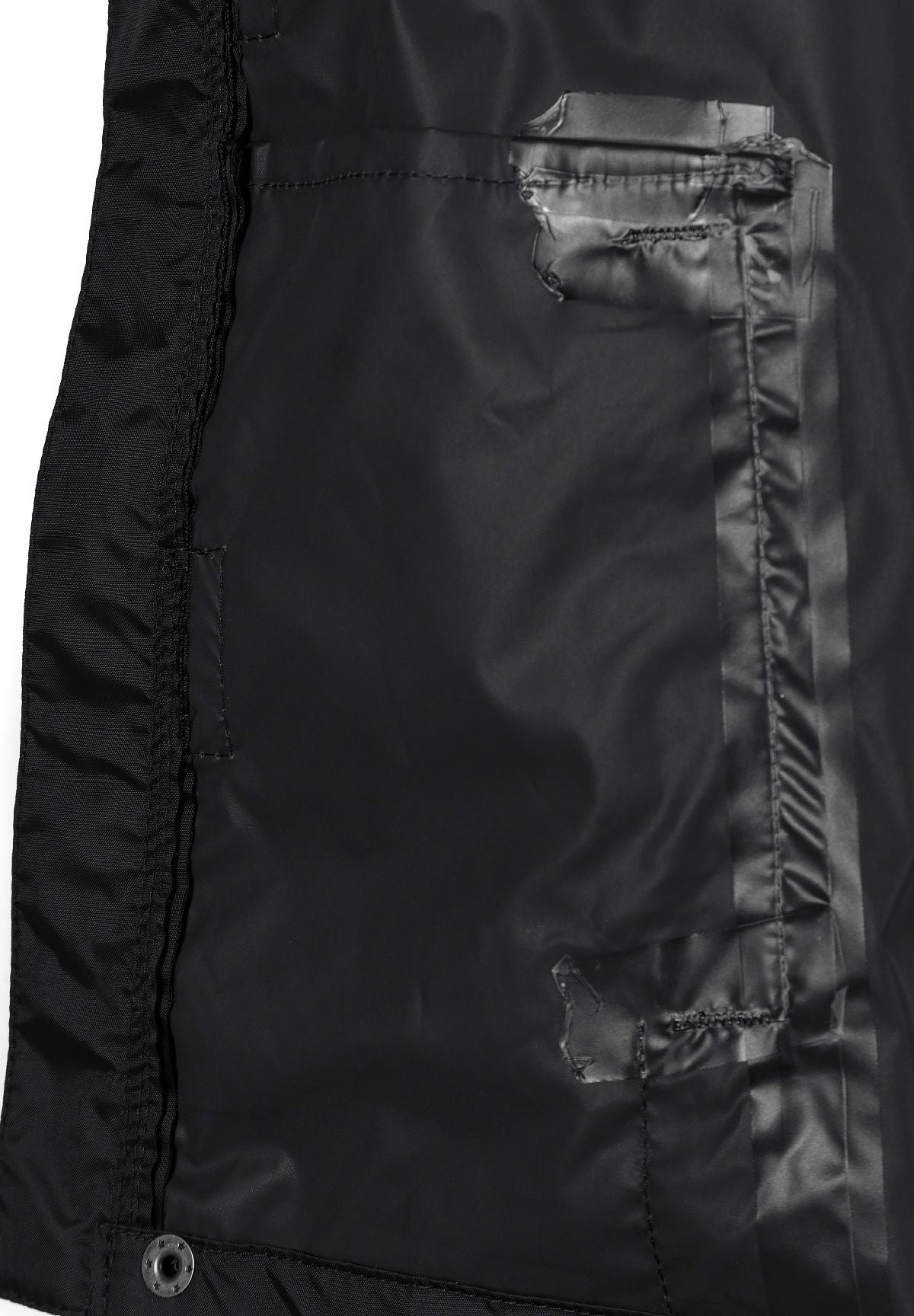 Close-up of the inside placket on the black packaway hooded jacket.