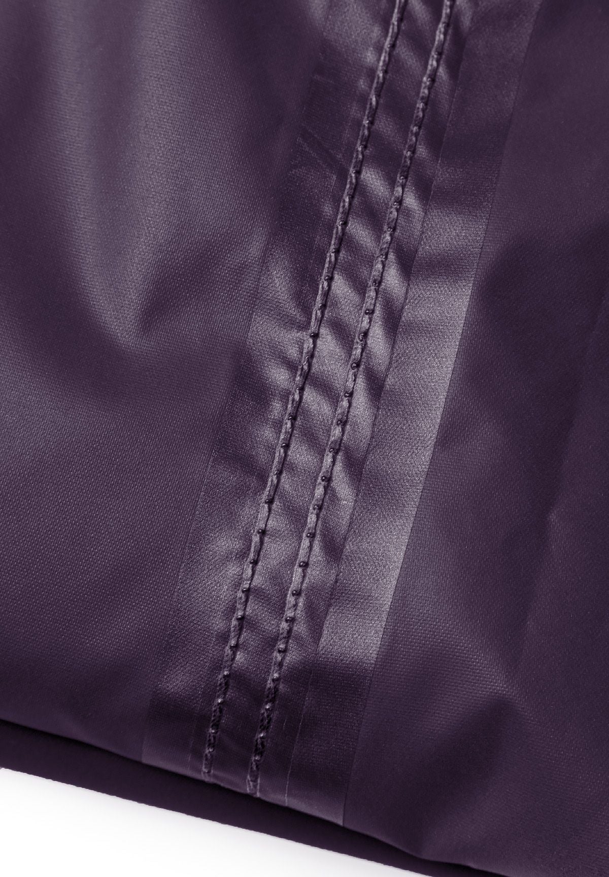 Purple packaway overtrousers, seam close-up.