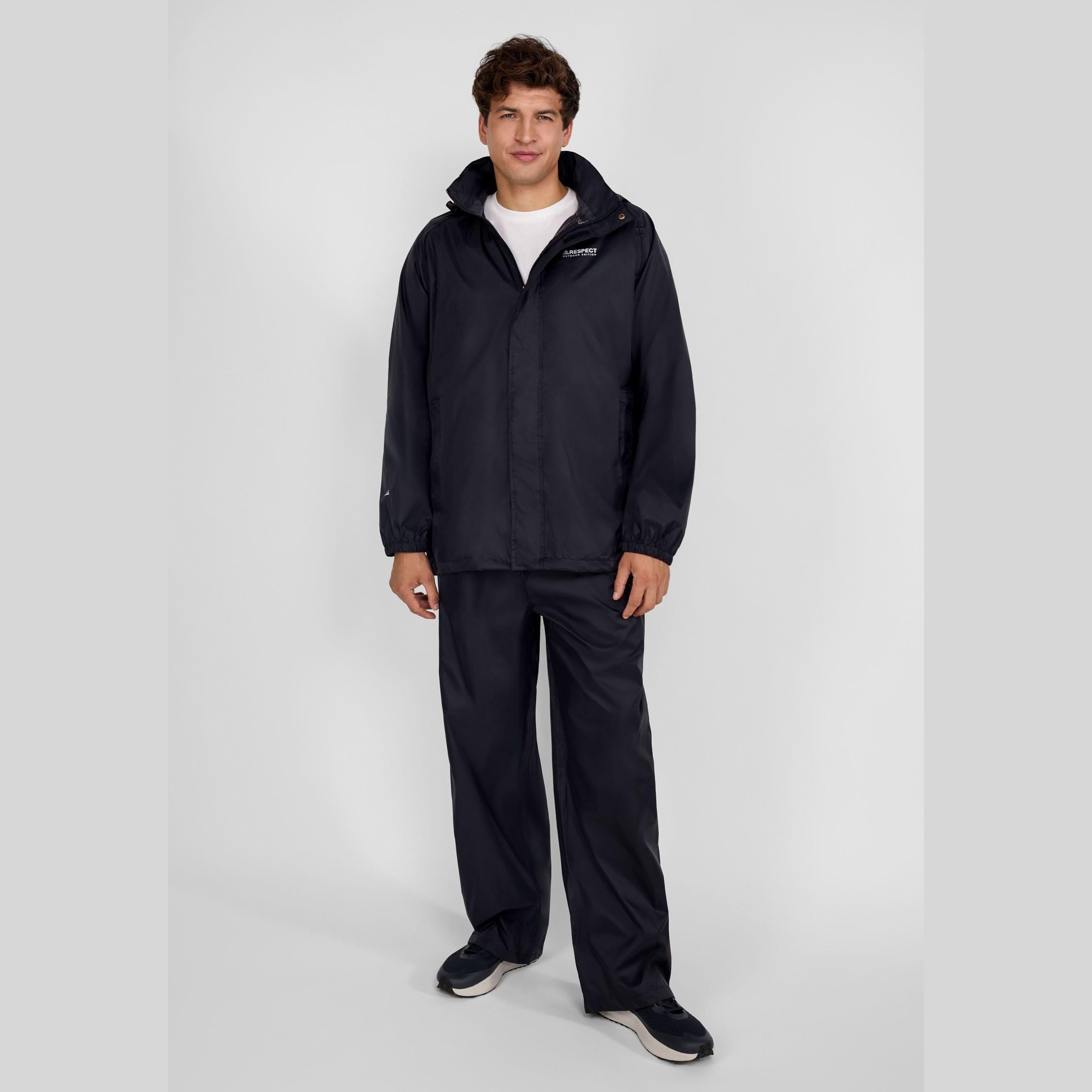 Man wearing black waterproof overpants and matching jacket with hood, elasticated waist, and adjustable leg hems.