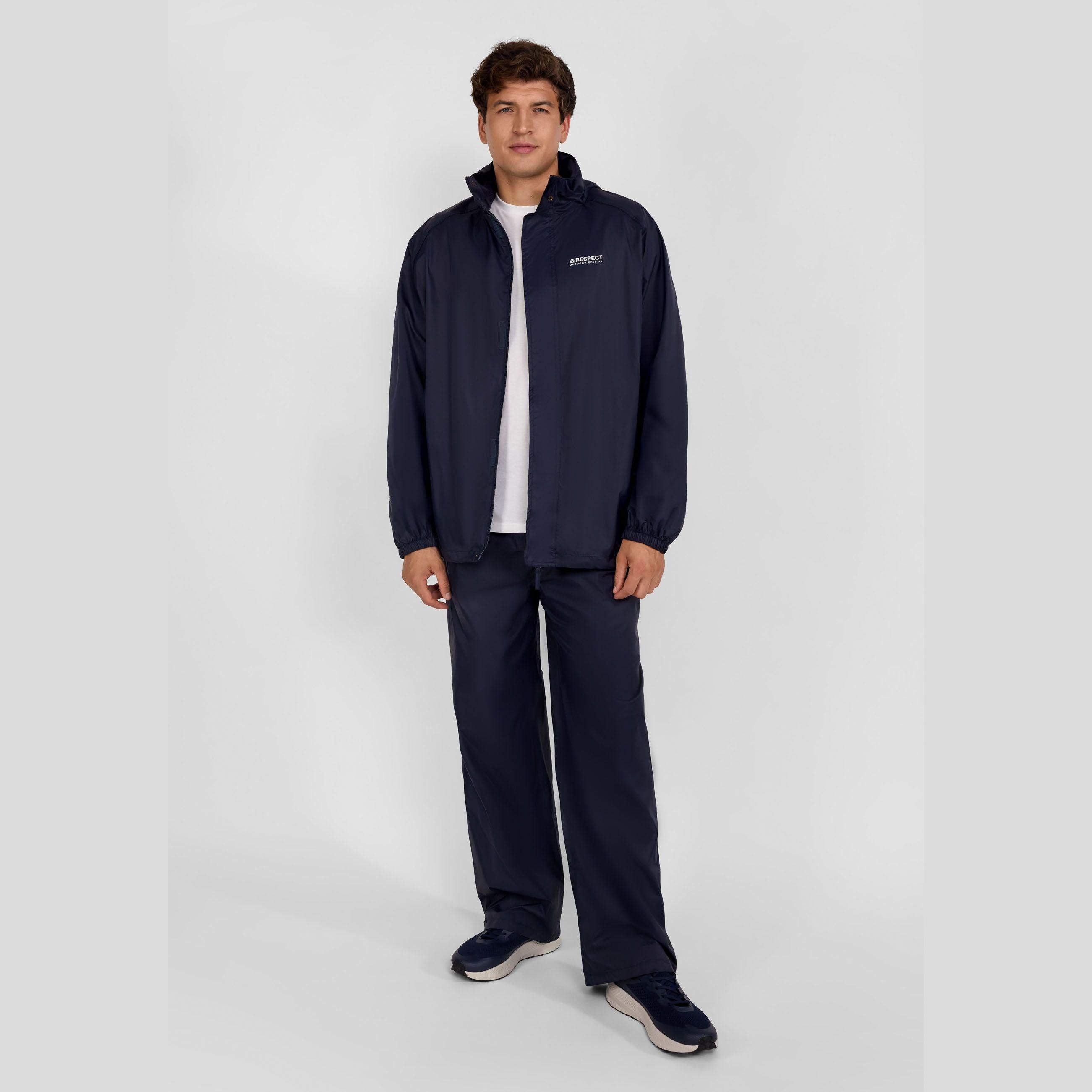 Man in navy waterproof packaway overpants and matching jacket.