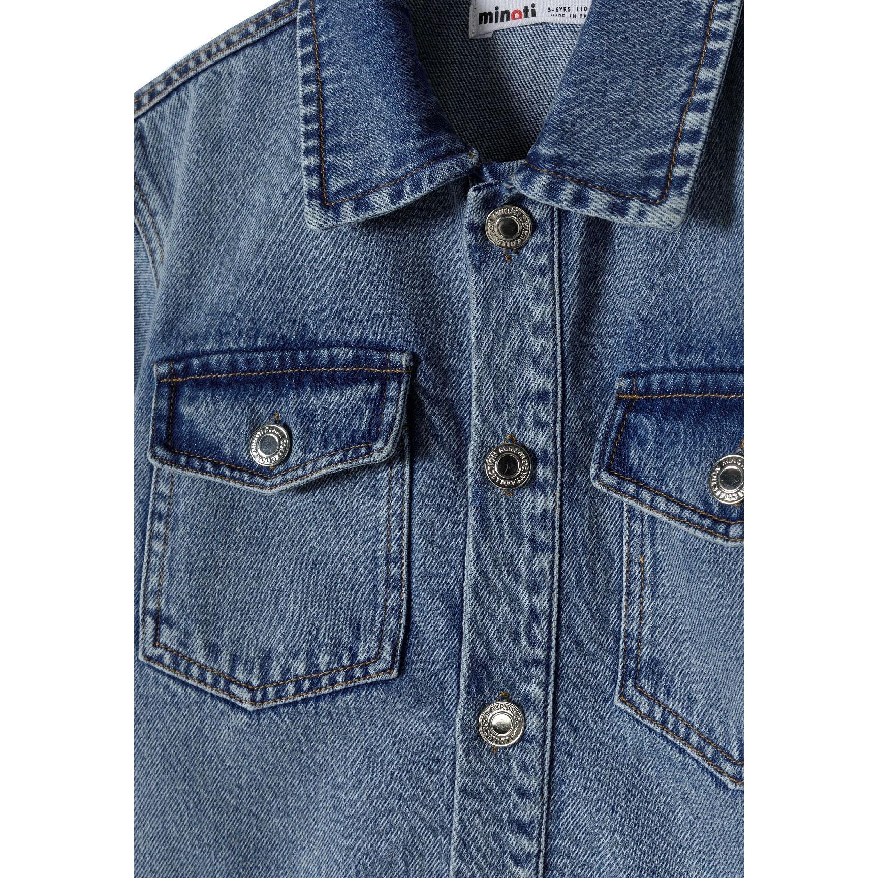 Close-up detail of navy denim shirt dress showing Minoti label, collar construction, chest pockets and silver press stud fastenings