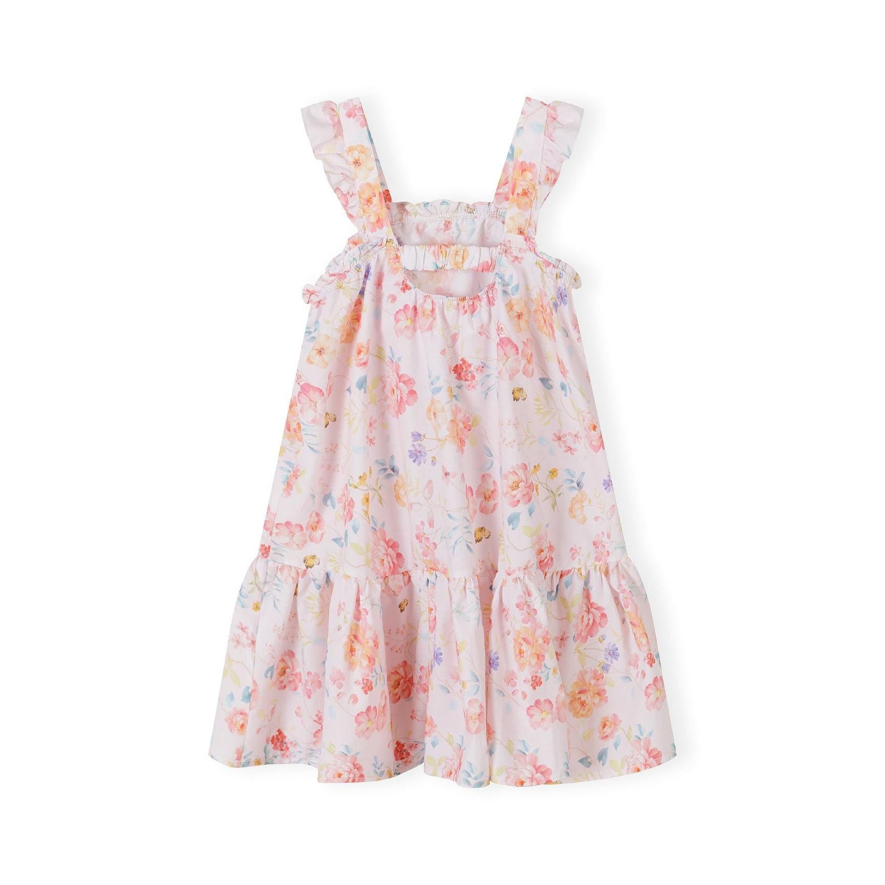 Flat lay of pink floral cotton dress with ruffled shoulder straps and tiered design against white background