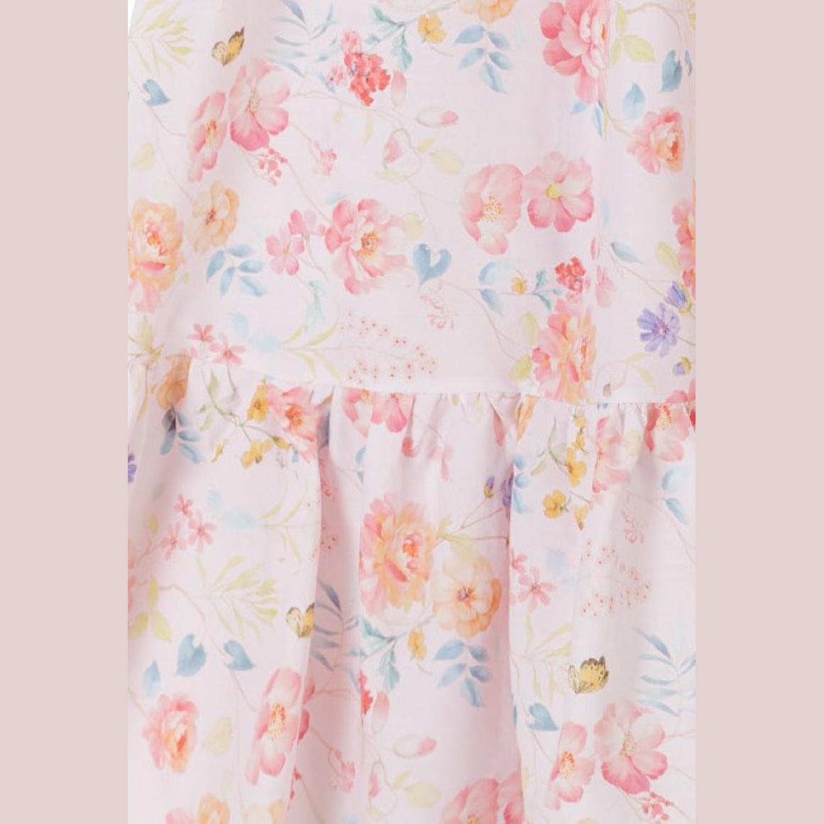 Close-up detail of pink floral watercolour print fabric showing delicate flowers, butterflies and ruffle trim