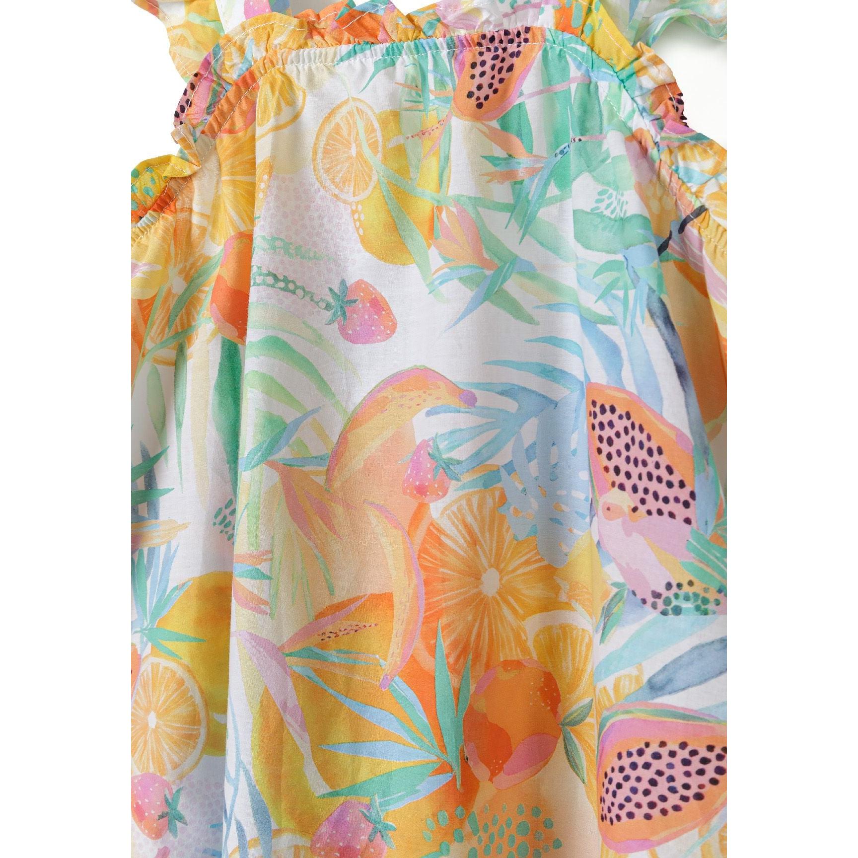 Close-up detail of tropical fruit print fabric showing citrus, watermelon, palm leaves and ruffle construction