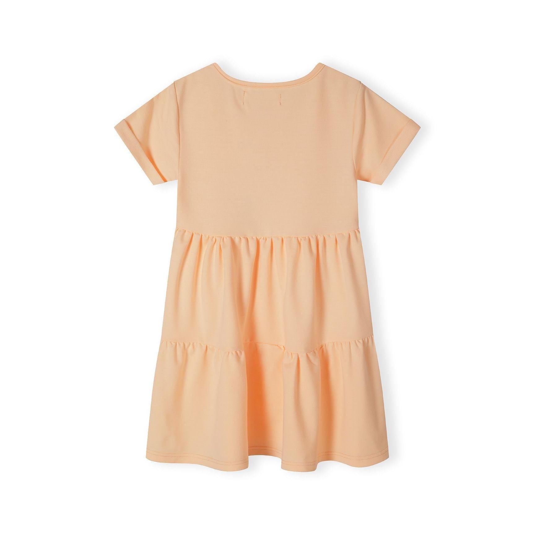 Back view of orange cotton fleece tiered dress showing plain design and flowing silhouette on white background