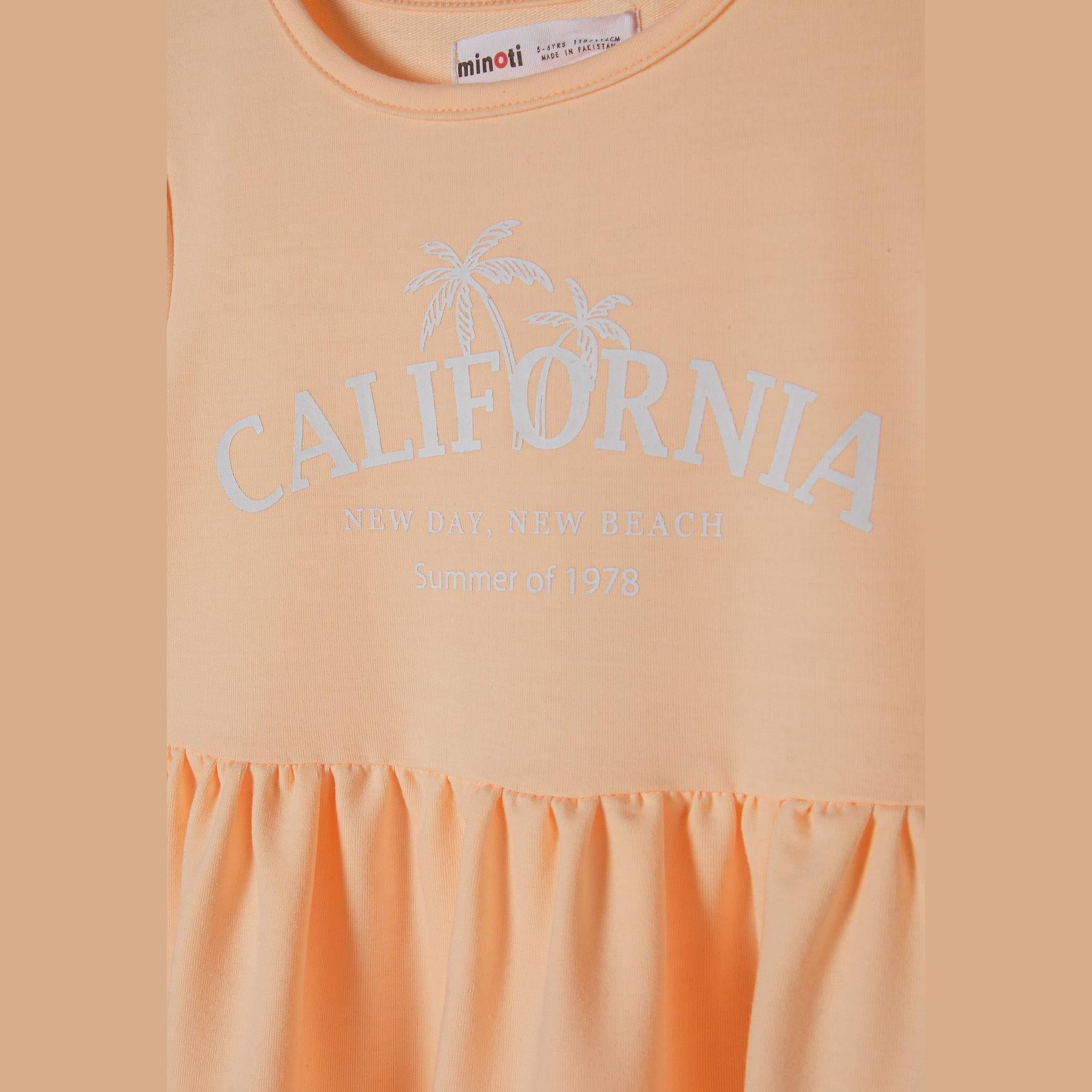 Close-up detail of orange dress showing Minoti label and California palm tree print with text on chest area