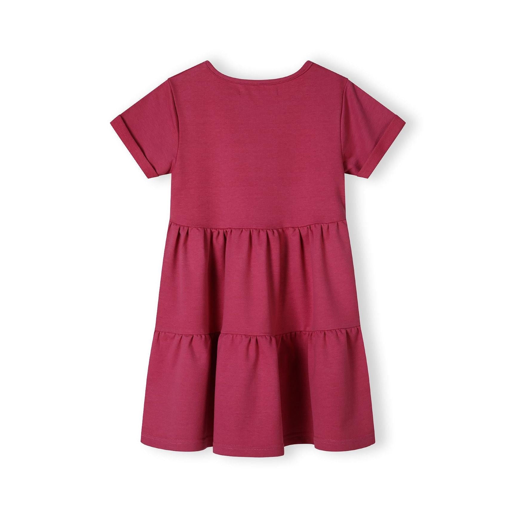 Back view of pink cotton fleece dress showing tiered construction and flowing silhouette on white background