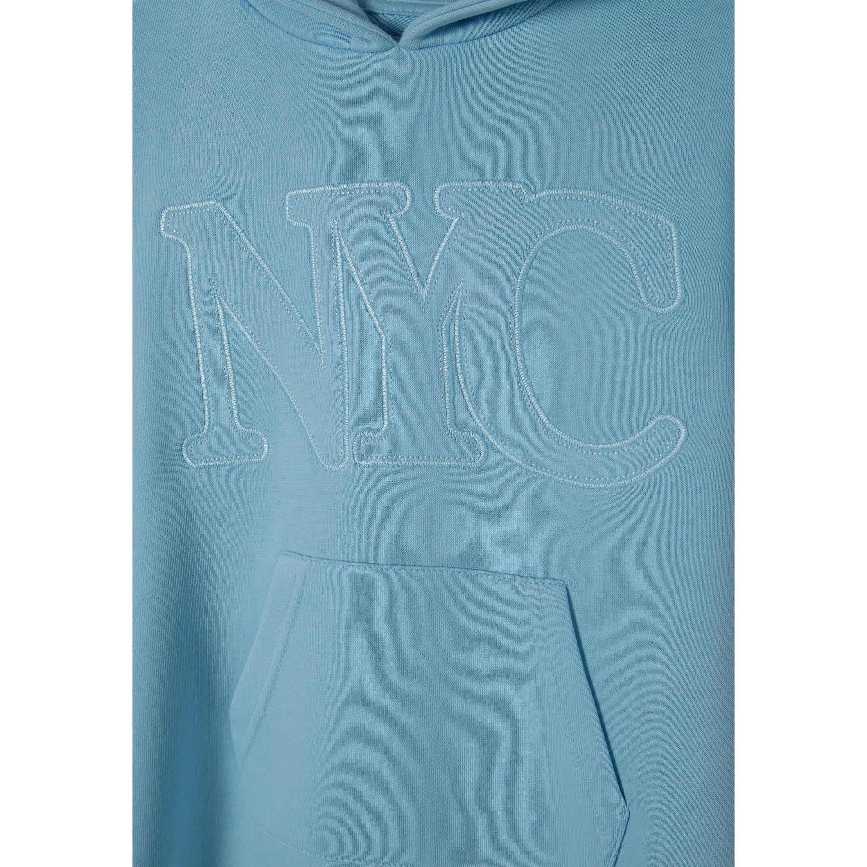 Close-up detail of light blue cotton fleece fabric showing NYC embossed lettering and kangaroo pocket on front of dress