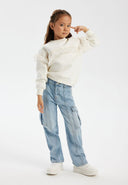 Girls light blue cargo jeans, front view, featuring multiple side pockets and a relaxed fit.