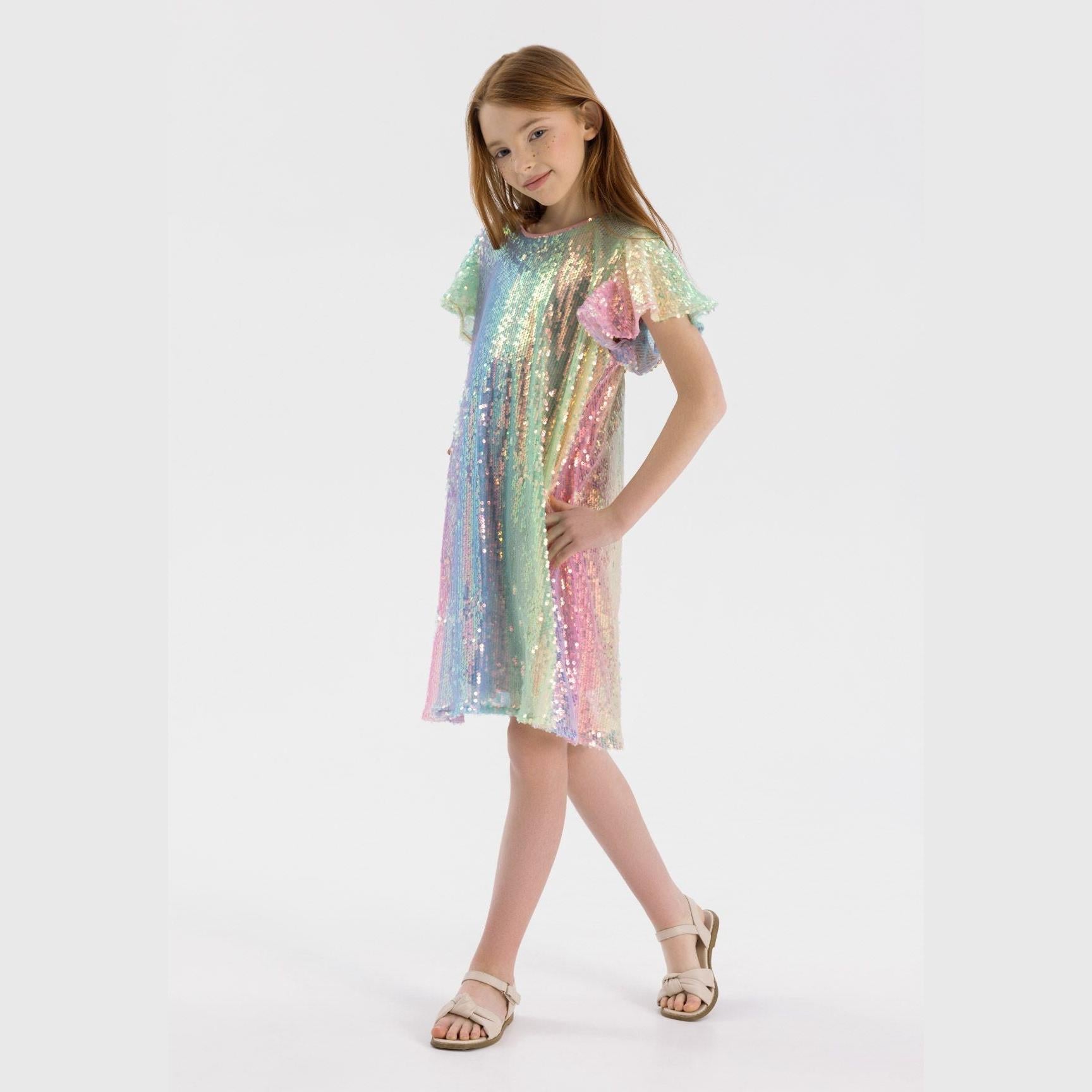 Girl wearing multicolour sequin dress with flutter sleeves, full body front view on white background, gold sandals
