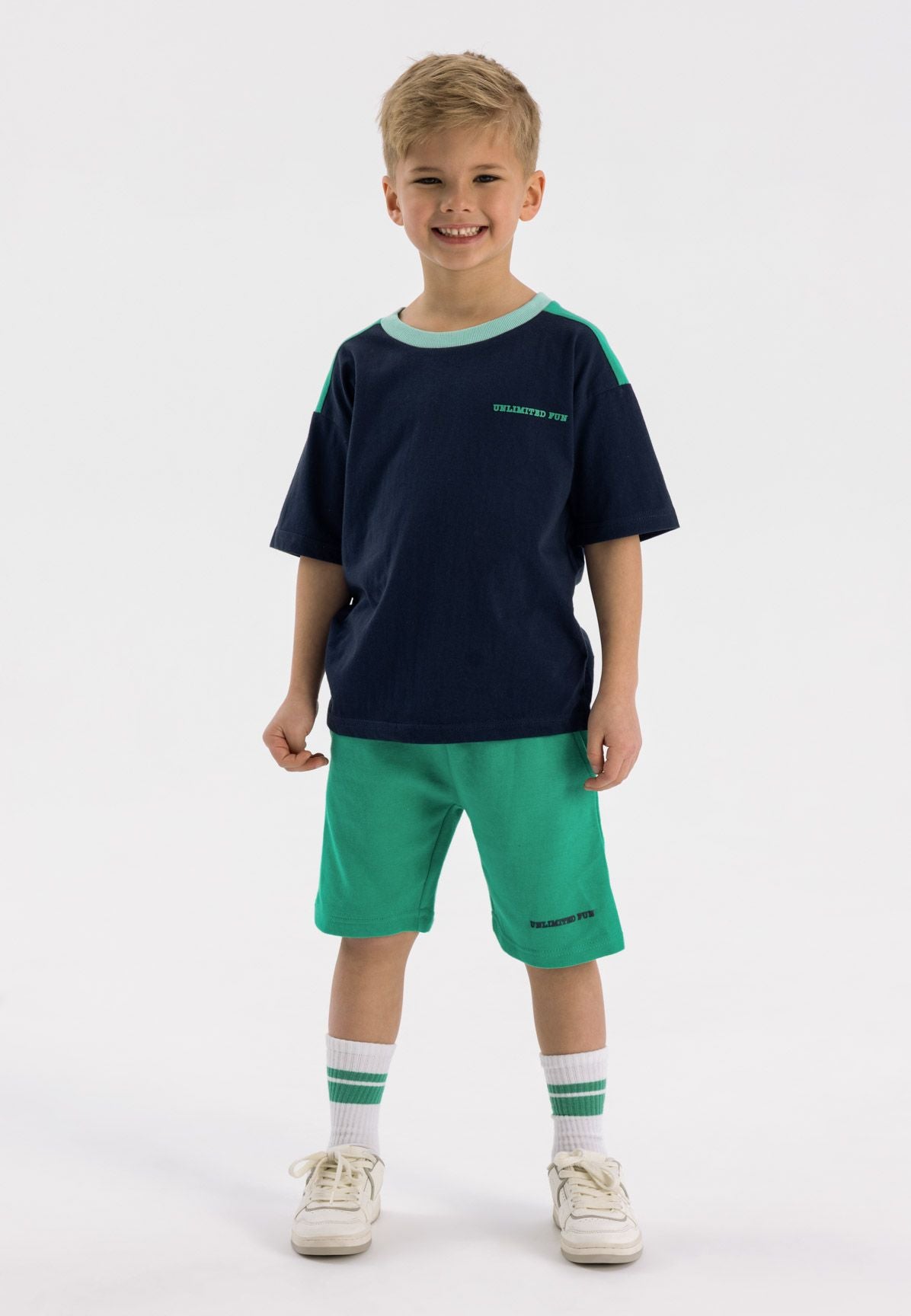 Navy and green t-shirt and shorts set, model front.