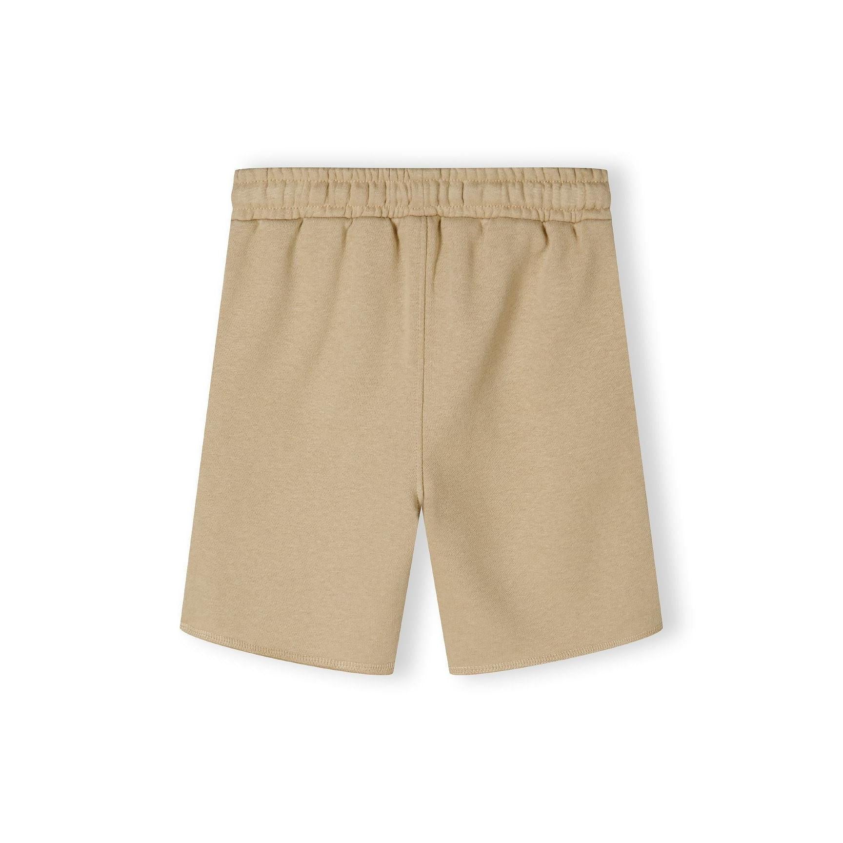 Close-up detail of beige fleece shorts waistband showing elasticated band with woven drawstring tie