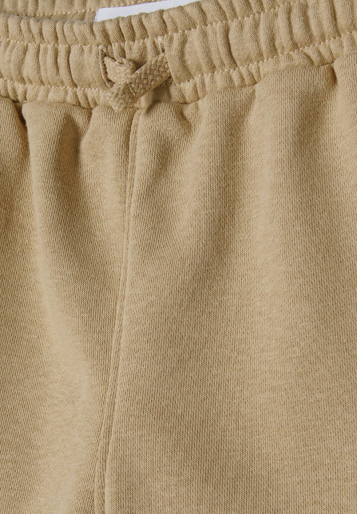 Beige t-shirt and shorts set, waist detail.