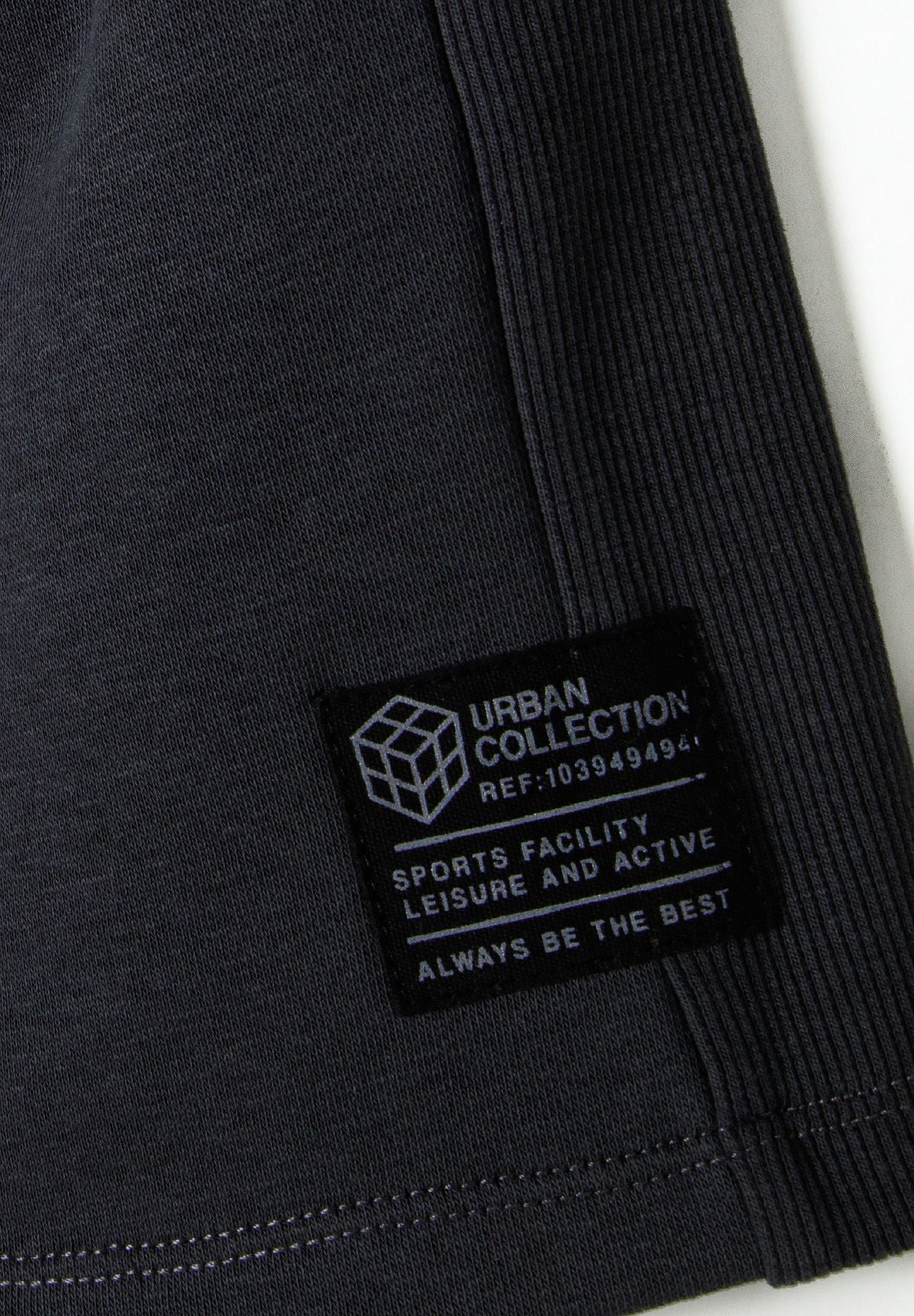 Charcoal jogger shorts, side panel and patch detail.