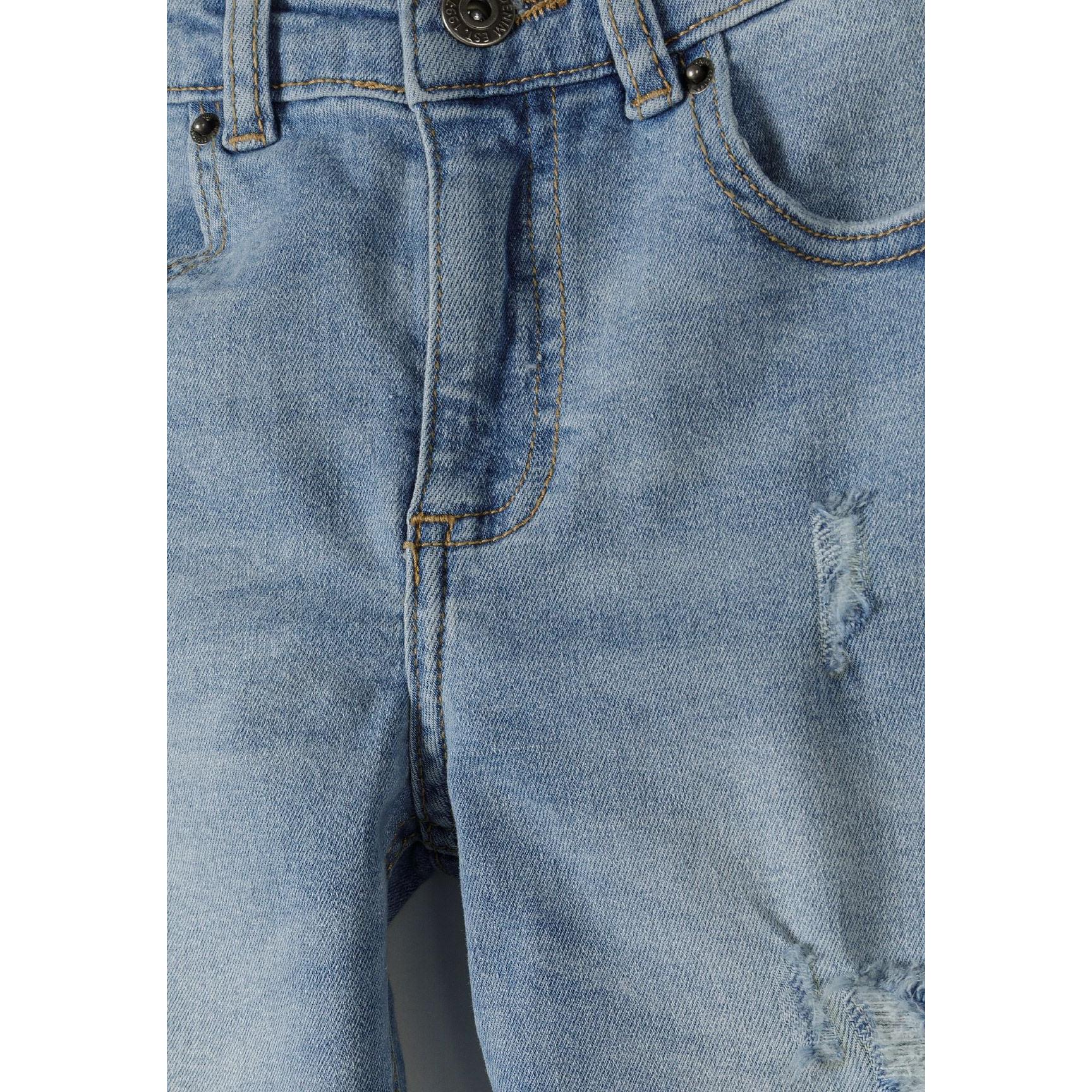 Close-up detail of light blue denim jeans showing ripped distressed areas, button closure, front pockets and orange contrast stitching