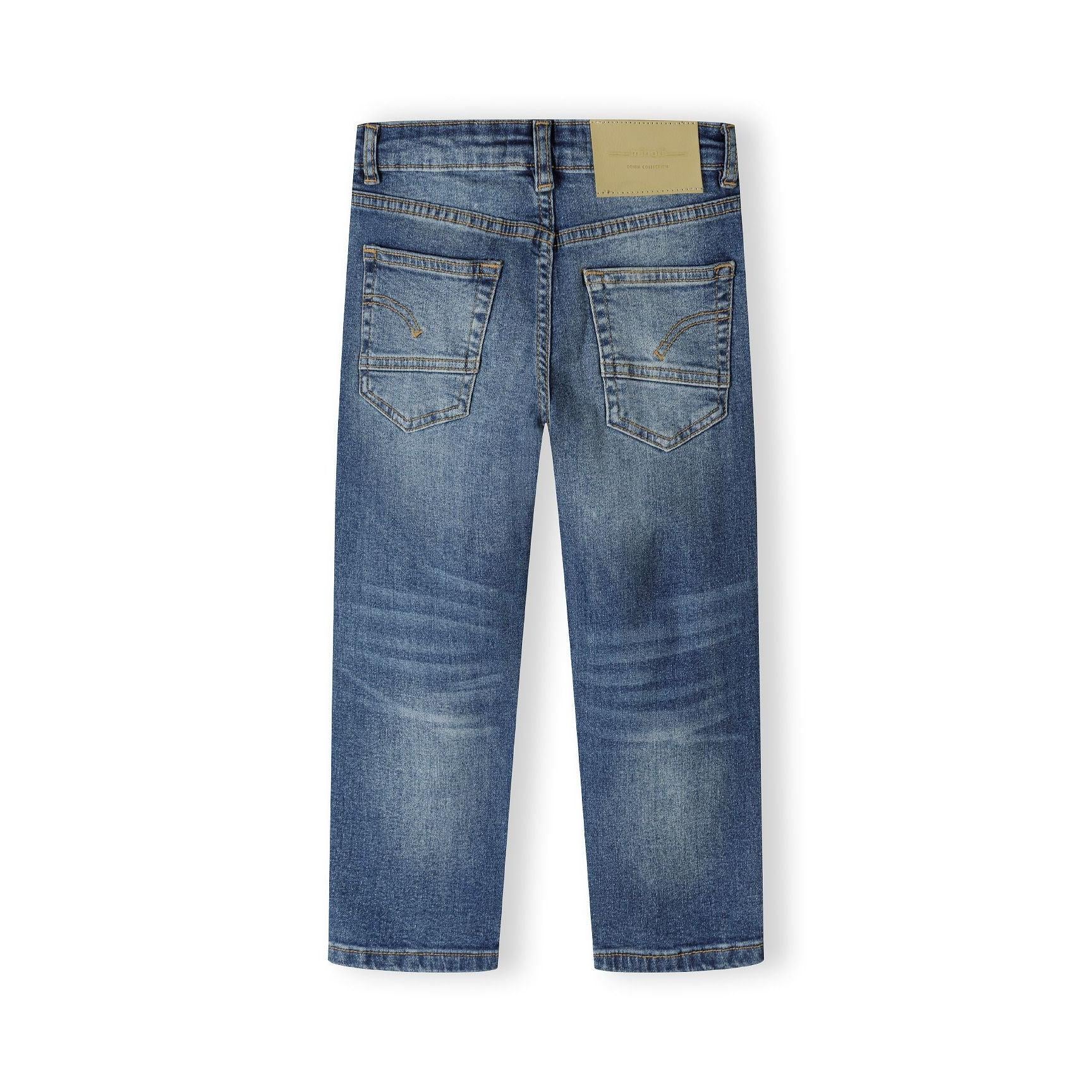 Back view of navy straight fit jeans showing rear pockets and tan leather patch detail on white background