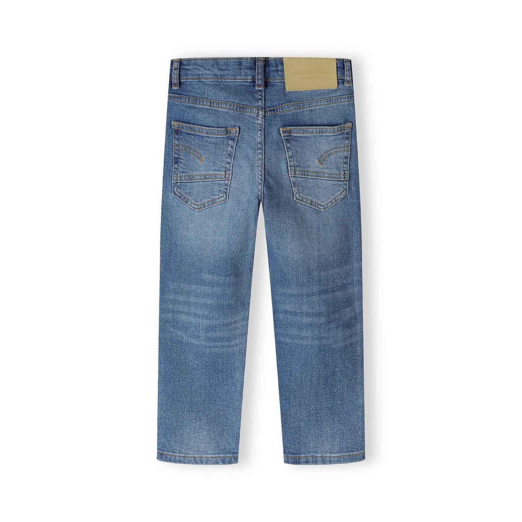 Back view of navy jeans showing rear pockets, waistband with brand label patch and overall straight leg silhouette on white background