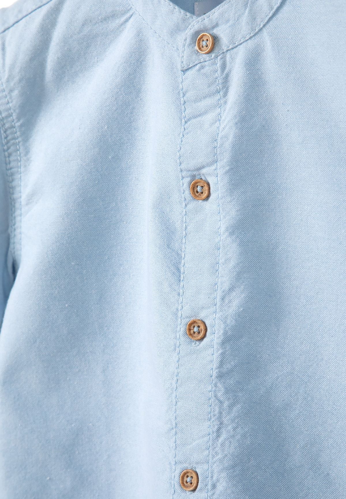 Light blue and beige grandad collar shirt and shorts set, shirt buttons detail.