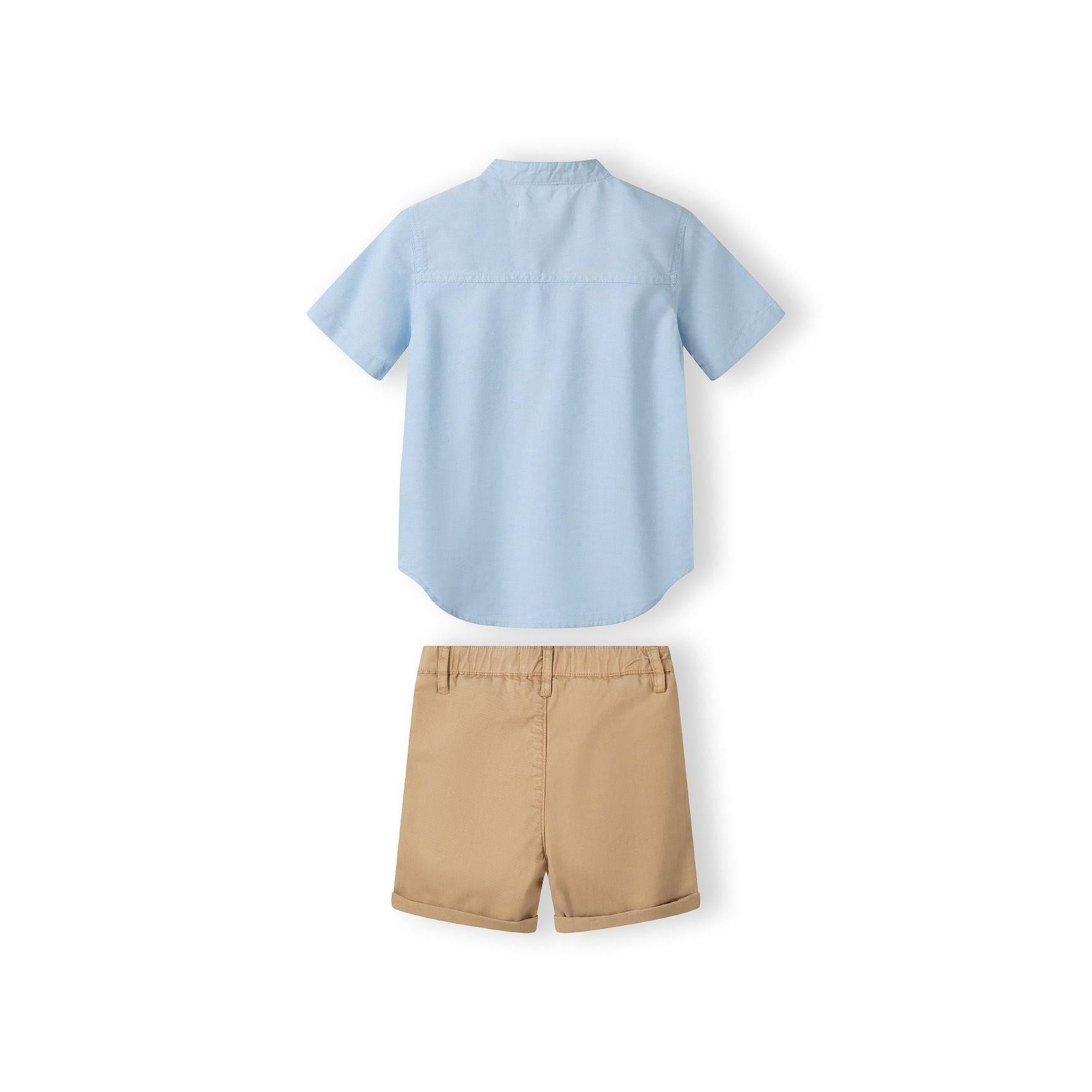 Close-up detail of stone beige chino shorts showing Minoti label, button closure and pocket construction