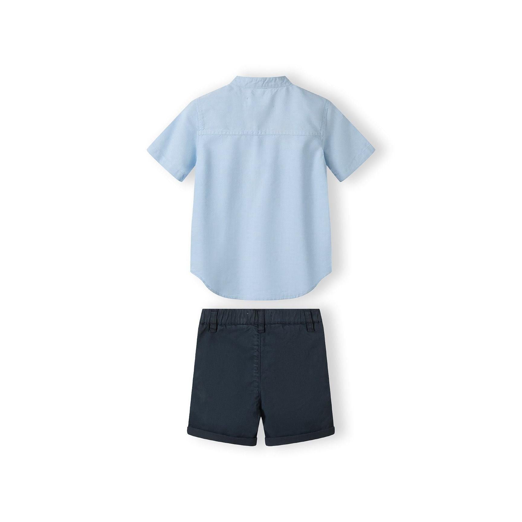 Close-up detail of navy shorts showing adjustable waistband with brown button and pocket construction