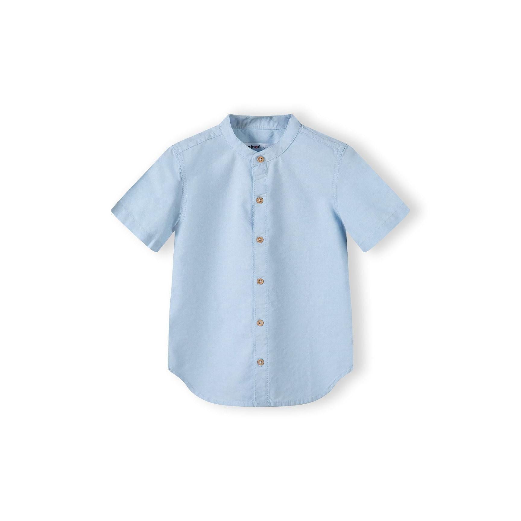 Close-up detail of navy shorts showing adjustable waistband with brown button and pocket construction