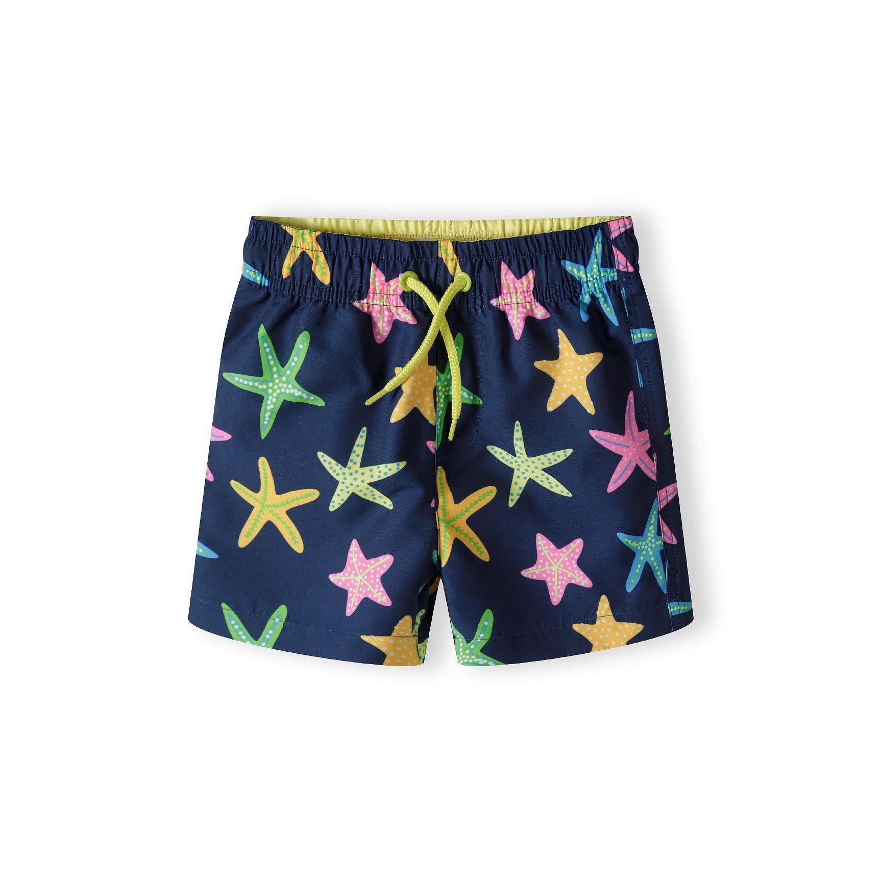 Navy board shorts with colourful starfish print featuring pink, yellow, green and blue starfish on dark blue background, shown flat against white background with adjustable drawstring waistband